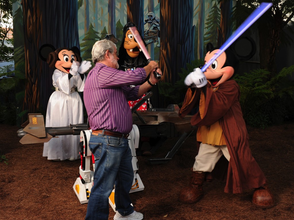 In this handout image provided by Disney, Star Wars creator George Lucas has a playful lightsaber duel with Jedi Mickey Mouse at Disney's Hollywood Studios theme park at Walt Disney World Resort in Lake Buena Vista, Fla., on Aug. 14, 2010. Disney announced Tuesday that it was buying Lucasfilm Ltd. for $4.05 billion.